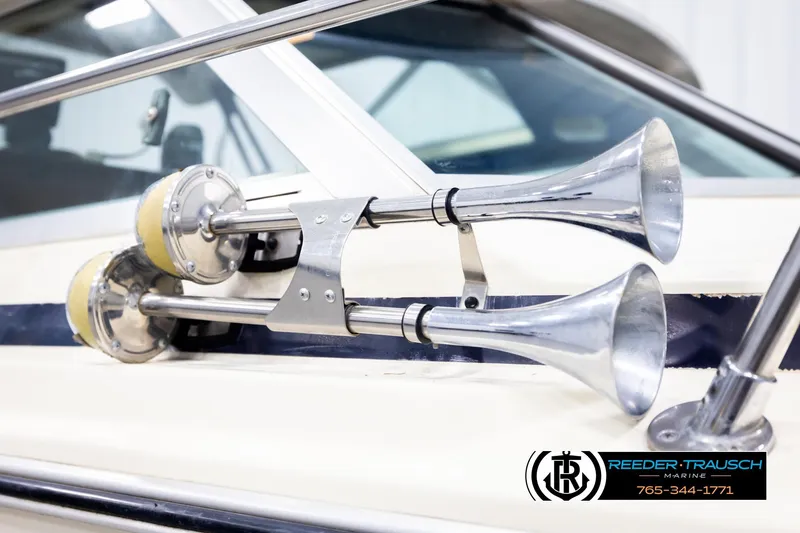 Slide: The Image of 1977 Searay 220 OV boat with dual chrome horns, Reeder-Trausch Marine logo visible. - 61