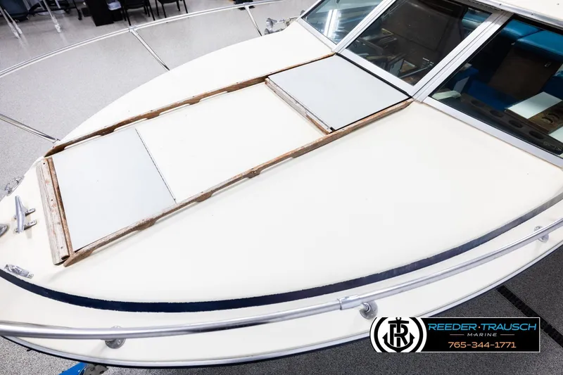 Slide: The Image of 1977 Searay 220 OV boat deck with windshield, displayed indoors at Reeder-Trausch Marine. - 9