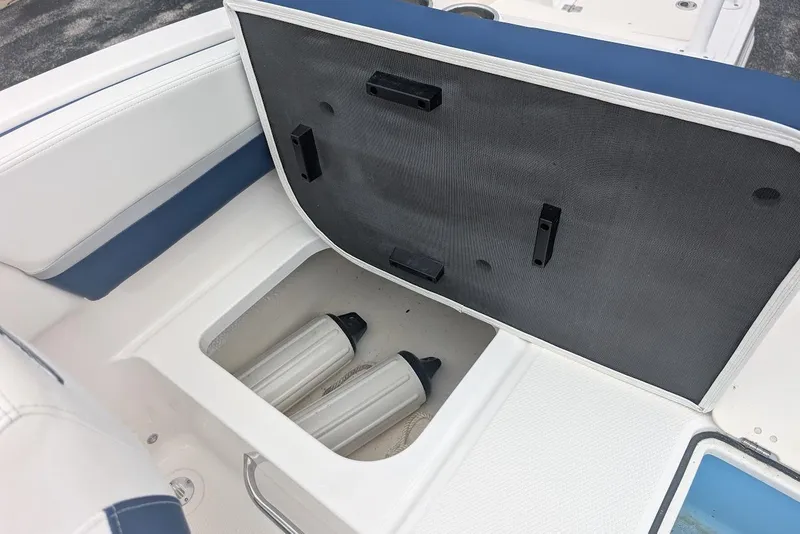Slide: The Image of 2018 Chaparral 191 Suncoast boat storage compartment with fenders inside. - 10