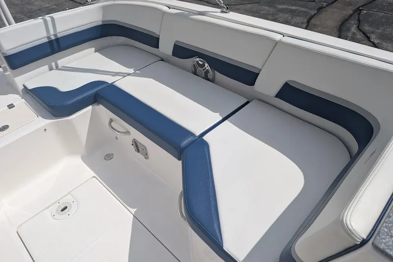 Slide: The Image of 2018 Chaparral 191 Suncoast boat interior with blue and white cushioned seating. - 11