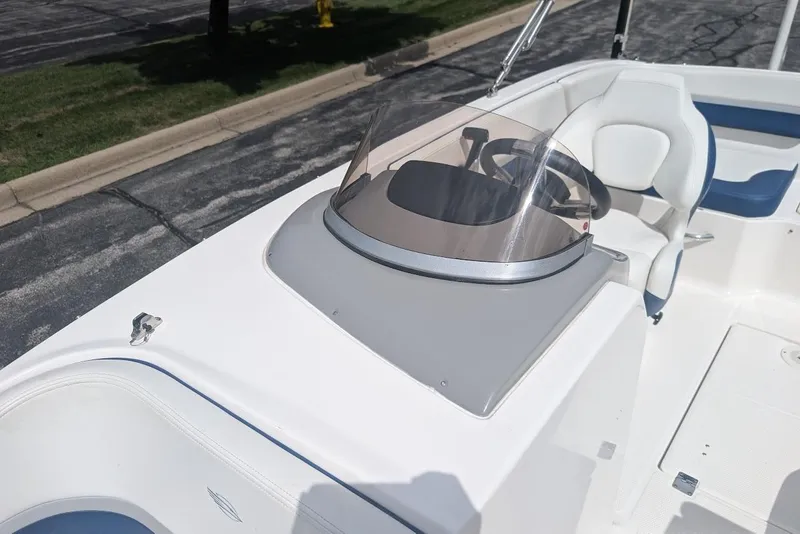 Slide: The Image of 2018 Chaparral 191 Suncoast boat cockpit with steering wheel and seating. - 20