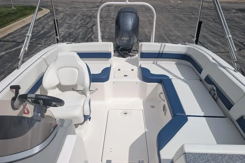 Slide: The Image of 2018 Chaparral 191 Suncoast boat interior with seating and steering wheel. - 21