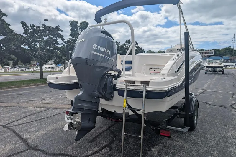 Slide: The Image of 2018 Chaparral 191 Suncoast boat with Yamaha engine on trailer, parked outdoors. - 4