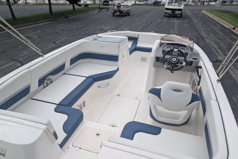 Slide: The Image of 2018 Chaparral 191 Suncoast boat interior with blue and white seating, steering console. - 5