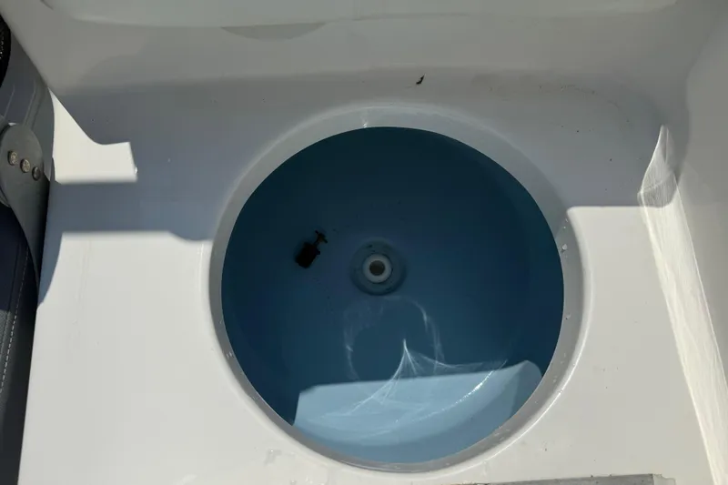 Slide: The Image of Livewell on 2017 Tidewater 196 DC Explorer boat, featuring a circular blue interior. - 17