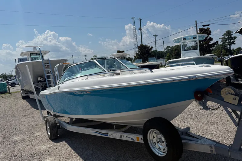 Slide: The Image of 2017 Tidewater 196 DC Explorer boat on trailer, displayed outdoors under a sunny sky. - 9