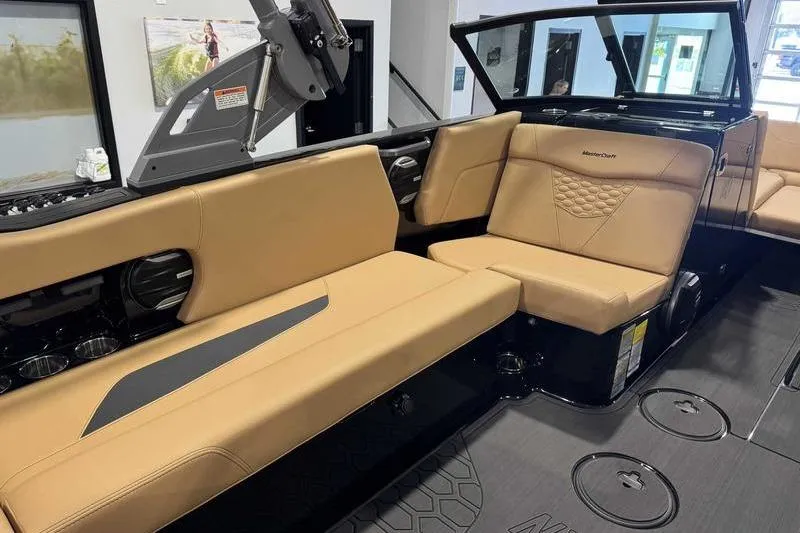 Slide: The Image of 2026 MasterCraft NXT22 boat interior with tan leather seating and modern design. - 13