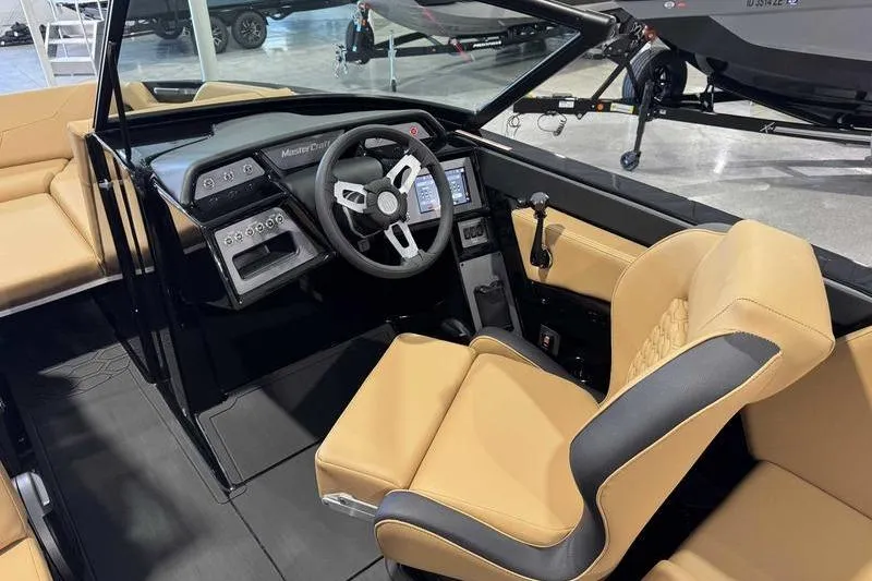 Slide: The Image of 2026 MasterCraft NXT22 boat interior with tan seating and modern dashboard. - 14