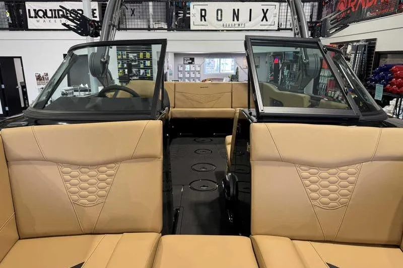 Slide: The Image of 2026 MasterCraft NXT22 boat interior with tan seating and modern design. - 16