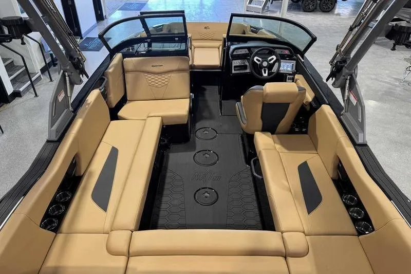 Slide: The Image of 2026 MasterCraft NXT22 boat interior with tan seating and modern dashboard design. - 7