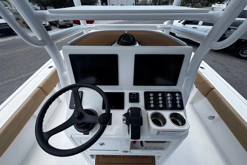 Slide: The Image of 2026 Caymas 28 HB boat dashboard with steering wheel, dual screens, and control panel. - 10