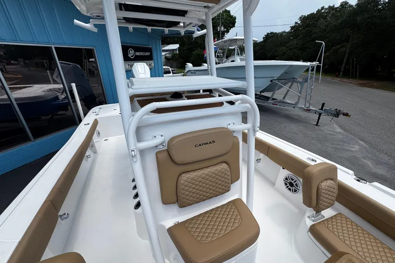 Slide: The Image of 2026 Caymas 28 HB boat interior with tan cushioned seating and white framework. - 7