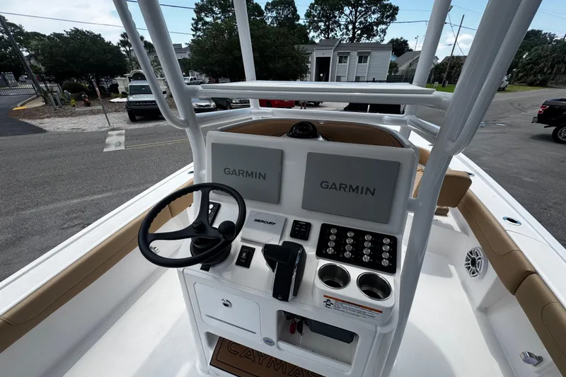 Slide: The Image of 2026 Caymas 28 HB boat dashboard with Garmin displays and Mercury controls. - 9