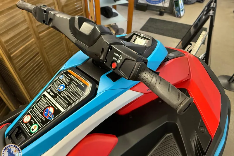 Slide: The Image of 2025 Yamaha WaveRunner JetBlaster DLX 2-Up, vibrant controls and handlebars, indoor display. - 2