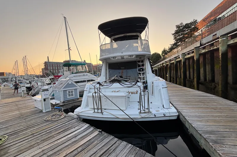 Slide: The Image of 1998 Carver 530 Voyager Pilothouse docked at marina during sunset. - 12