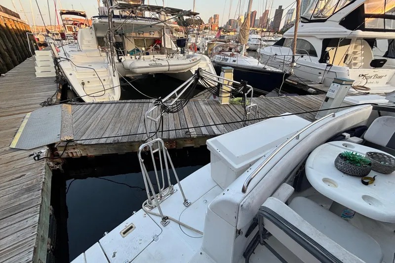 Slide: The Image of 1998 Carver 530 Voyager Pilothouse docked at marina with other boats. - 14