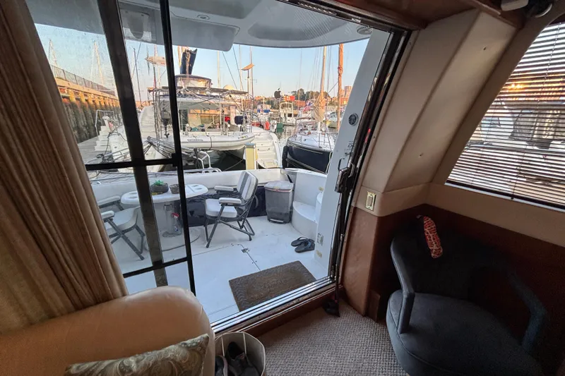 Slide: The Image of Interior view of 1998 Carver 530 Voyager Pilothouse yacht with marina backdrop. - 16