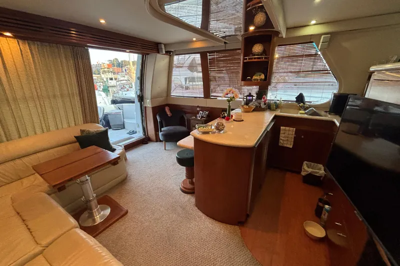 Slide: The Image of Luxurious interior of 1998 Carver 530 Voyager Pilothouse yacht with elegant seating and modern amenities. - 18