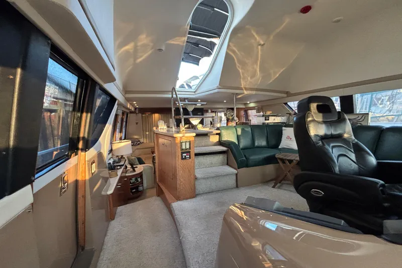 Slide: The Image of Interior of 1998 Carver 530 Voyager Pilothouse yacht, featuring luxurious seating and modern design. - 2
