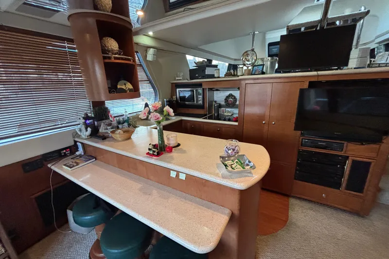 Slide: The Image of Interior of 1998 Carver 530 Voyager Pilothouse with modern kitchen and entertainment area. - 22