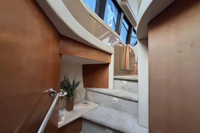 Slide: The Image of Interior staircase of 1998 Carver 530 Voyager Pilothouse with carpeted steps and wooden accents. - 24