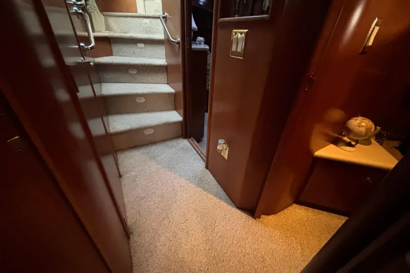 Slide: The Image of Interior of 1998 Carver 530 Voyager Pilothouse with carpeted stairs and wooden paneling. - 26