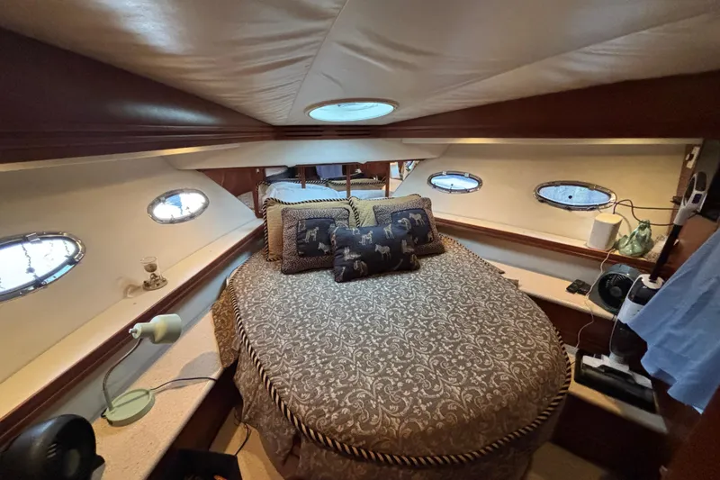 Slide: The Image of Luxurious cabin interior of 1998 Carver 530 Voyager Pilothouse yacht with elegant bedding. - 27