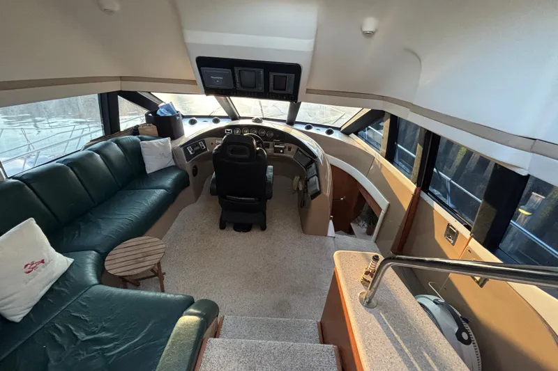 Slide: The Image of Interior of 1998 Carver 530 Voyager Pilothouse with helm, seating, and panoramic windows. - 3
