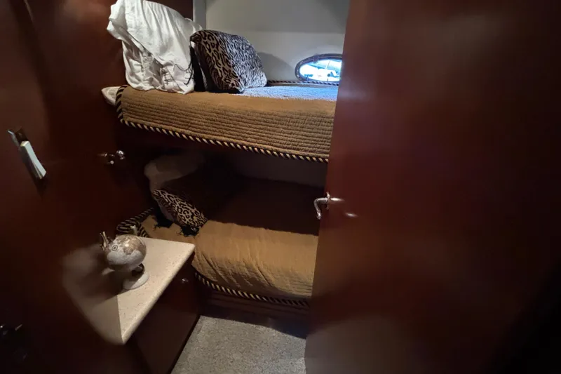 Slide: The Image of Bunk beds in 1998 Carver 530 Voyager Pilothouse cabin with cozy decor. - 30