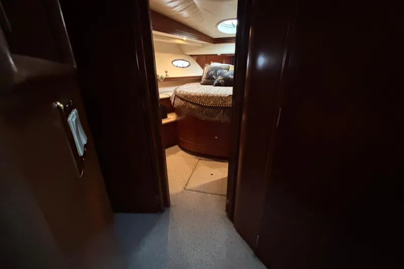 Slide: The Image of Interior view of 1998 Carver 530 Voyager Pilothouse bedroom with cozy bed and wooden finish. - 32