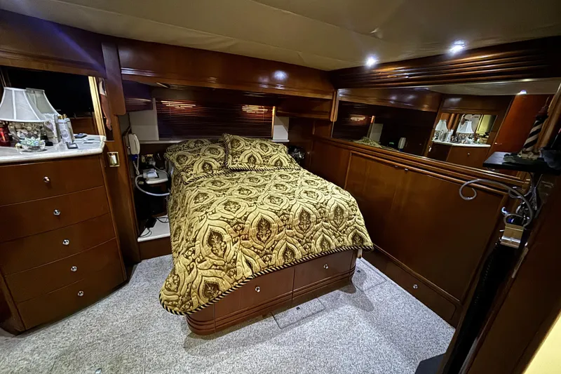 Slide: The Image of Luxurious bedroom interior of 1998 Carver 530 Voyager Pilothouse yacht with elegant wood finish. - 37