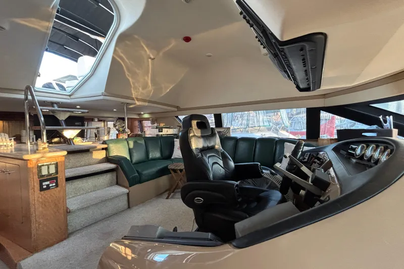Slide: The Image of Interior of 1998 Carver 530 Voyager Pilothouse with luxurious seating and helm. - 38