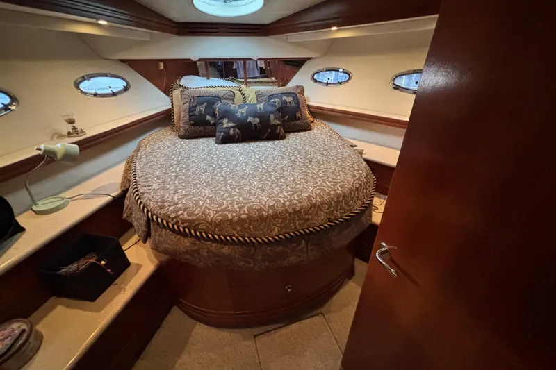 Slide: The Image of Luxurious bedroom interior of 1998 Carver 530 Voyager Pilothouse yacht with elegant bedding. - 4