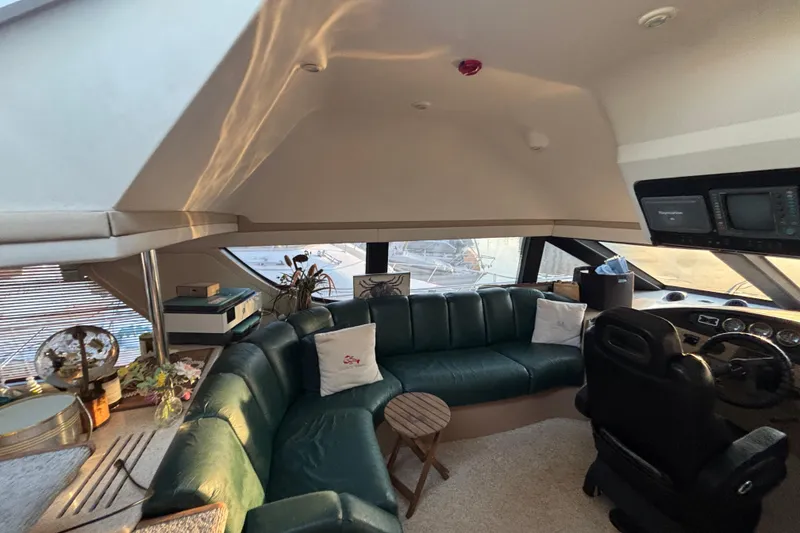 Slide: The Image of Luxurious interior of a 1998 Carver 530 Voyager Pilothouse with leather seating and helm. - 43