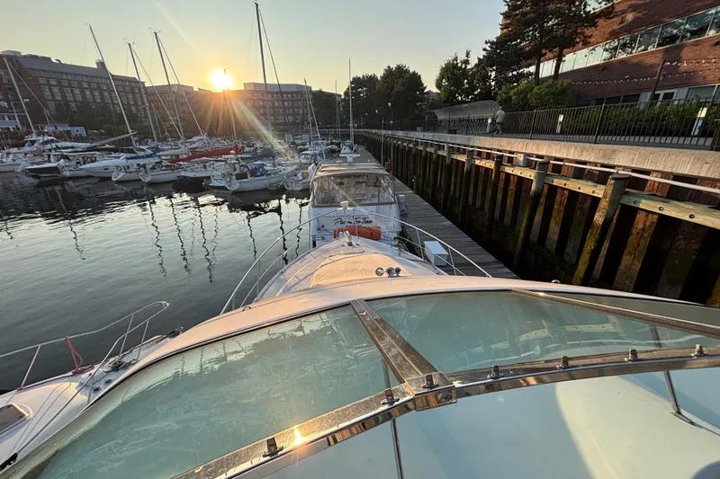 Slide: The Image of 1998 Carver 530 Voyager Pilothouse docked at sunset in a marina. - 45