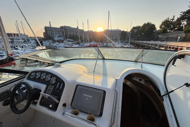 Slide: The Image of 1998 Carver 530 Voyager Pilothouse yacht at marina during sunset, with visible control panel. - 46