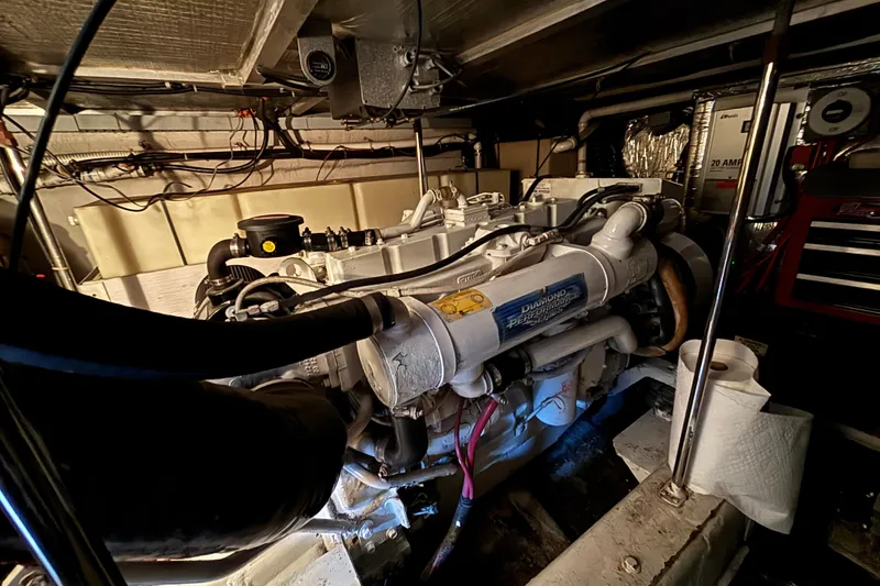 Slide: The Image of Engine room of a 1998 Carver 530 Voyager Pilothouse yacht, showcasing machinery and components. - 51
