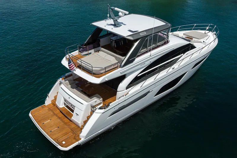 Slide: The Image of 2020 Princess F70 yacht on serene blue water, showcasing luxury design and spacious deck. - 10