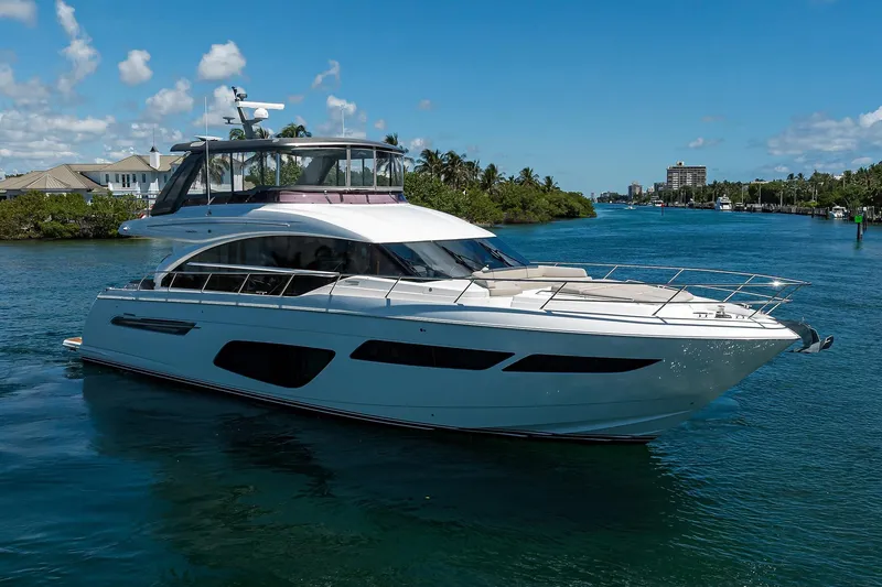 Slide: The Image of Luxurious 2020 Princess F70 yacht cruising on a sunny day, surrounded by scenic waterfront views. - 17