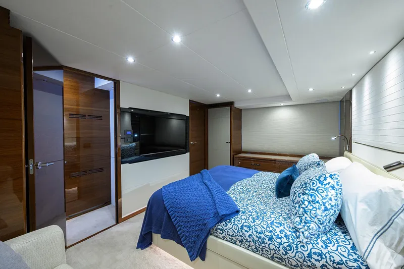 Slide: The Image of Luxurious 2020 Princess F70 yacht bedroom with elegant blue bedding and modern decor. - 37