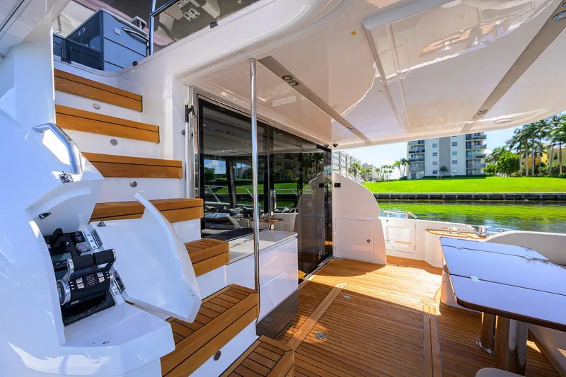 Slide: The Image of Luxurious 2020 Princess F70 yacht interior with wooden stairs and outdoor seating area. - 4