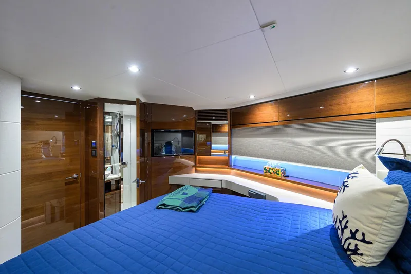 Slide: The Image of Luxurious 2020 Princess F70 yacht cabin with modern decor and blue bedding. - 41