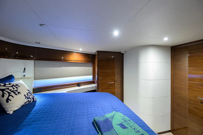 Slide: The Image of Luxurious cabin interior of 2020 Princess F70 yacht with blue bedding and modern design. - 42