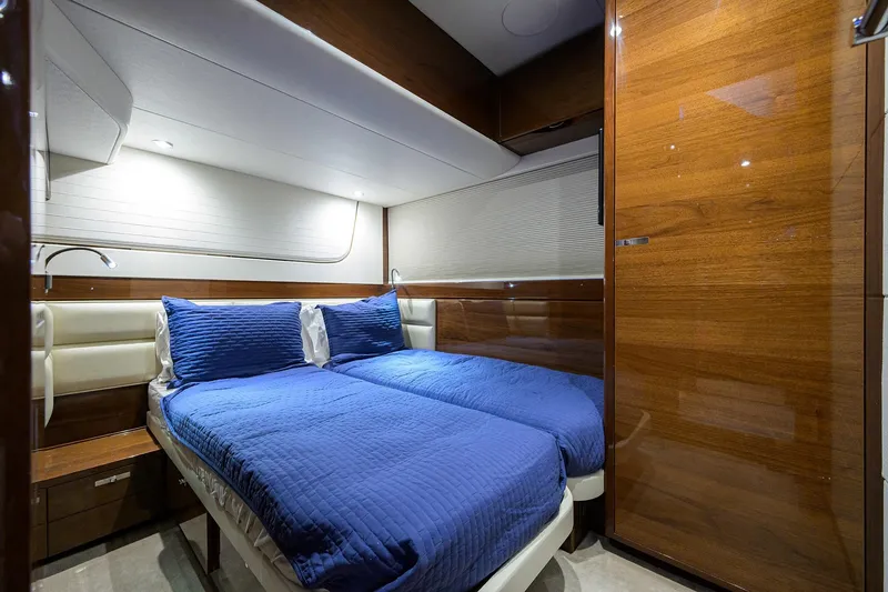 Slide: The Image of Luxurious 2020 Princess F70 yacht cabin with twin beds and elegant wood paneling. - 46