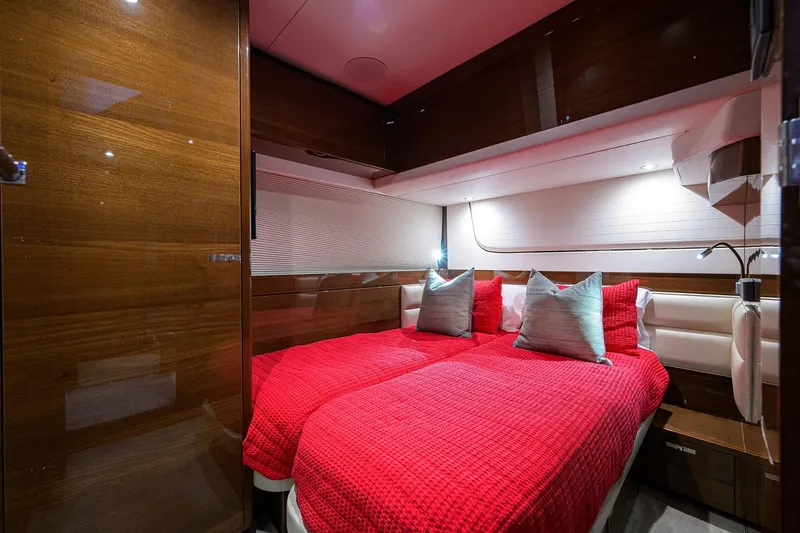 Slide: The Image of Luxurious cabin interior of 2020 Princess F70 yacht with red bedding and wood paneling. - 49