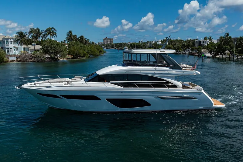 Slide: The Image of Luxurious 2020 Princess F70 yacht cruising on a scenic waterway under a clear blue sky. - 5