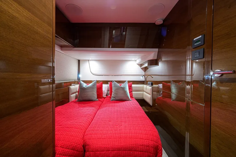 Slide: The Image of Luxurious 2020 Princess F70 yacht cabin with red bedding and elegant wood paneling. - 50