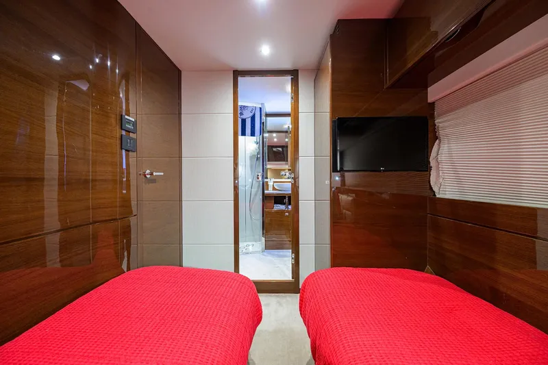 Slide: The Image of Luxurious 2020 Princess F70 yacht cabin with twin beds, red bedding, and modern decor. - 52