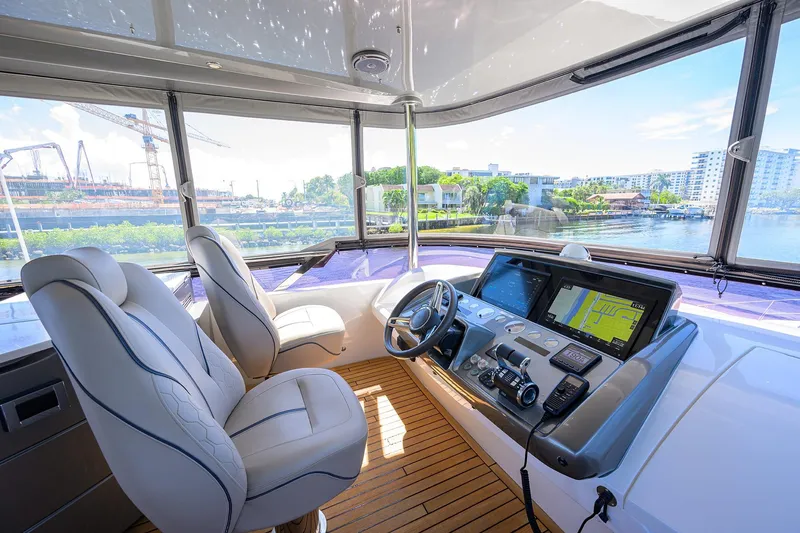 Slide: The Image of Luxurious 2020 Princess F70 yacht helm with modern navigation system and waterfront view. - 59