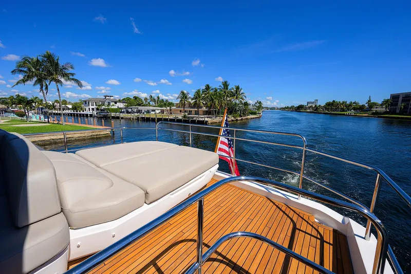 Slide: The Image of Luxurious 2020 Princess F70 yacht deck with scenic waterfront view and clear blue sky. - 66